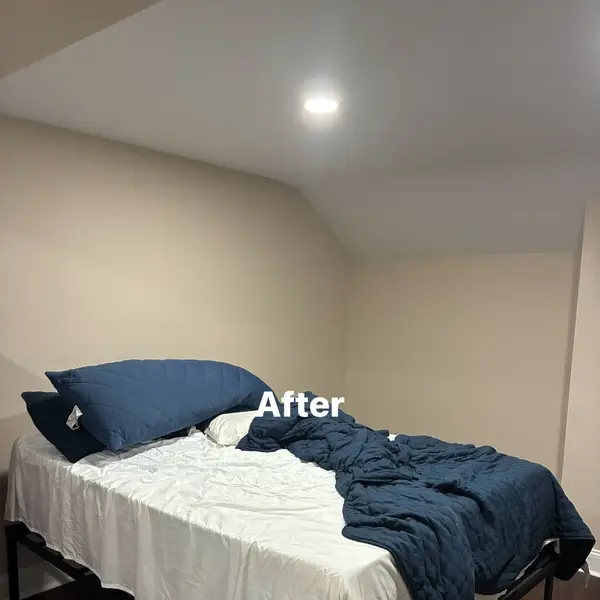 Bedroom after drywall patch preparation and repainting by JM Painting Services