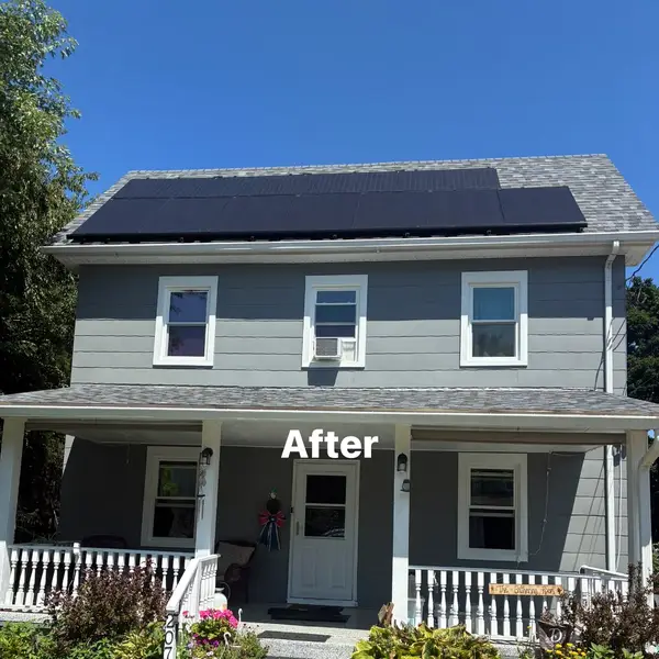After view of a two-story Clayton New Jersey home painted Cityscape gray with white trim