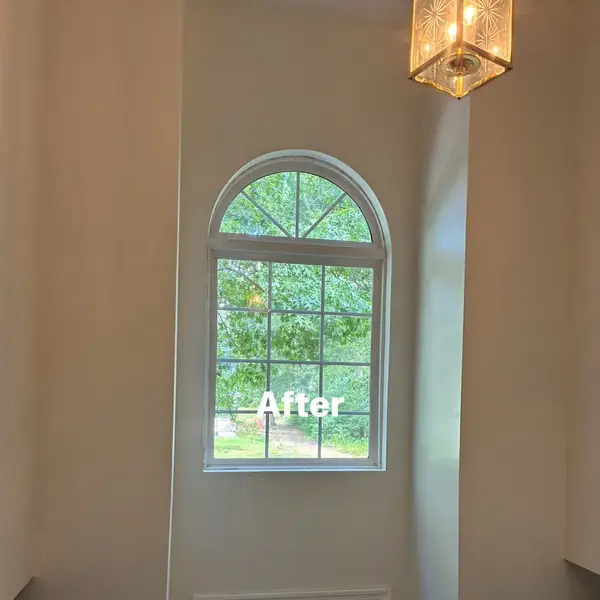 After view of the arched foyer window and repainted wall