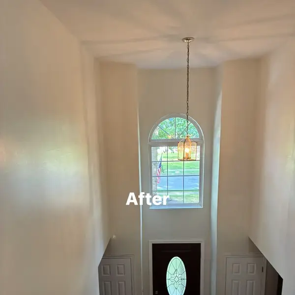 Two-story Franklinville foyer after a bright neutral interior repaint