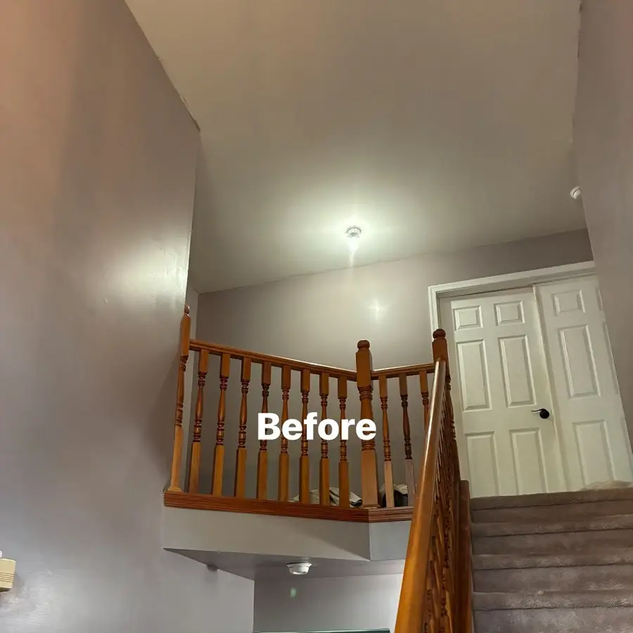 Before view of the Franklinville stair landing and foyer walls