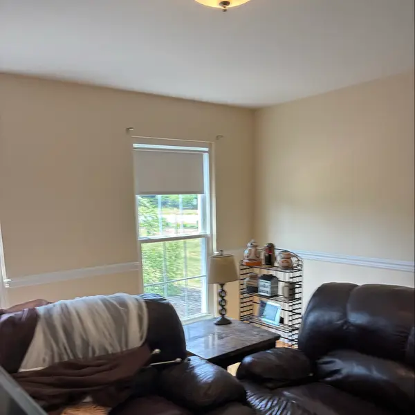 Finished interior room wall near a tall window