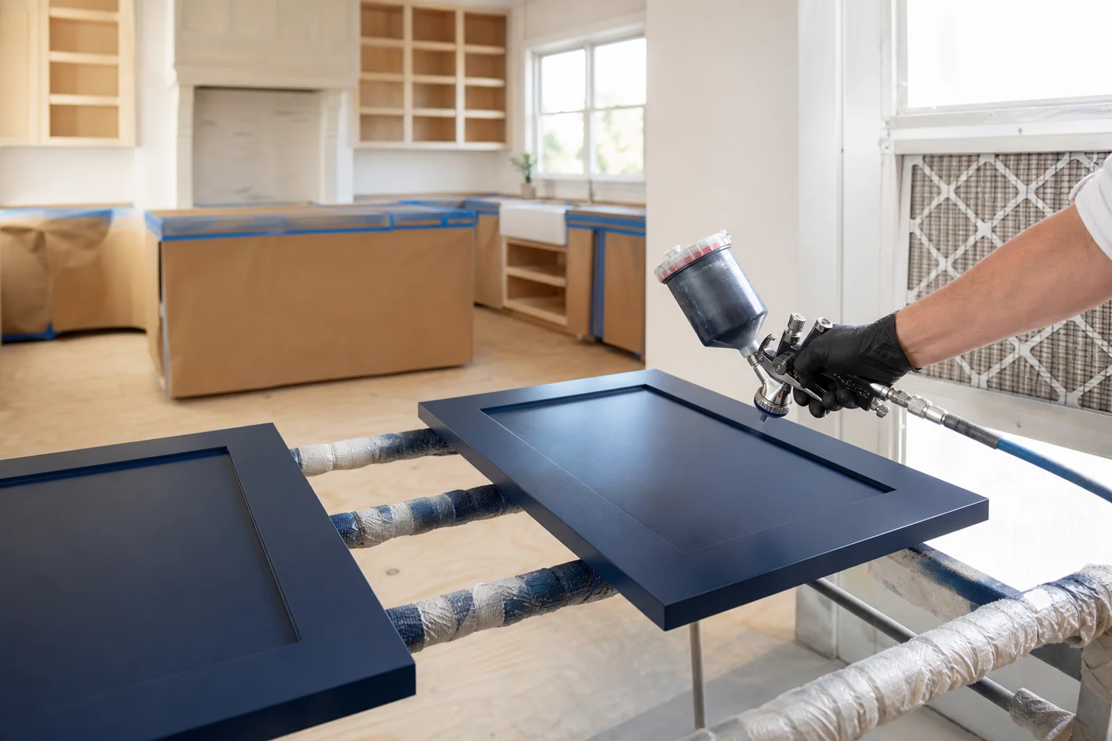 Kitchen cabinet doors receiving a smooth professional painted finish