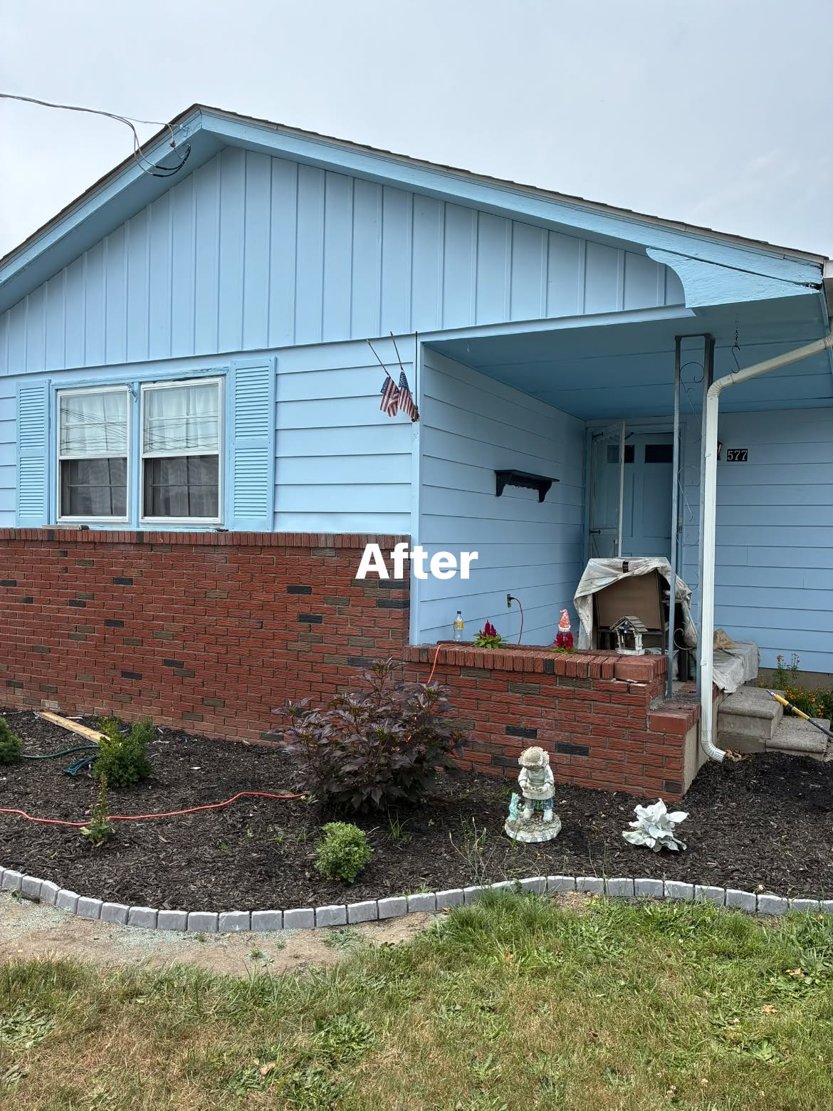 The same Magnolia ranch after its two-tone blue exterior repaint